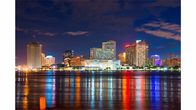 New Orleans skyline at night with light reflections on the river