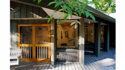 view of a building with gallery spaces in the woods