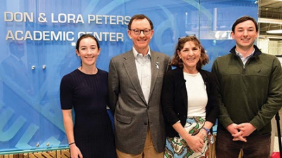 Peters family The Peters family: duaghter, father (Don), mother (Lora) and son stand in front of a blue sign that reads "Don & Lora Peters Academic Center".