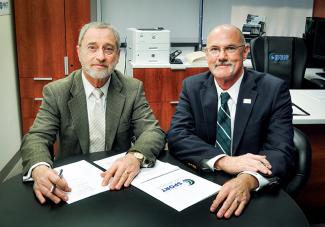 Dr. James Kelly (left), Avalon Fund representative, and Tulane’s Dr. Greg Stewart (right) sign the agreement for the creation of the Center for Brain Health.