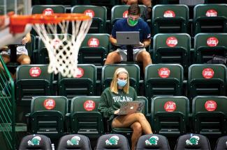 students socially distanced in the Devlin FieldHouse