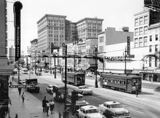 1950s era Canal Street in New Orleans with streetcars and stores