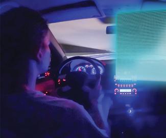 interior of car at night with person driving with glowing computer screen