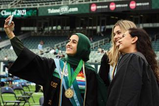 students take selfies at A. B. Freeman's 2021 commencement exercises