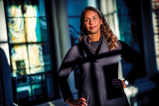 Mia Bagneris stands in front a museum at sunset