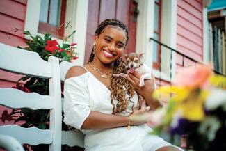 2022 graduate Mikala Nellum on porch with dog
