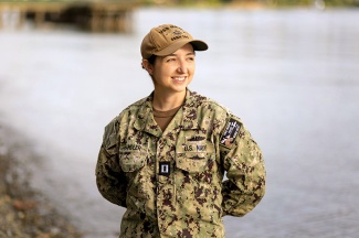 Erin Chandler stands wearing U S Navy camouflage uniform