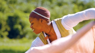 Jarrell Hamilton dances in a reenactment of a Congo Square sequence.