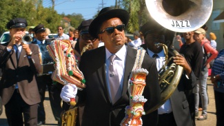 Grand Marshall Mary Blanco leads a funeral procession