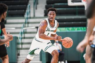 Green Wave's men basketball team guard Sion James on the court