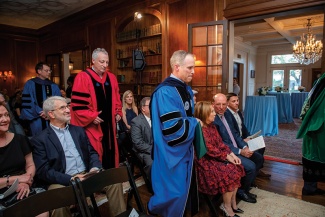 Dean Brian Edwards, Provost Robin Forman and Professor Michael Cohen process in academic regalia