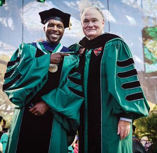Leslie Odom, Jr. wearing a medal and President Fitts 