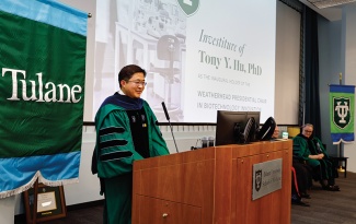 Tony Hu speaks at the podium during his investiture