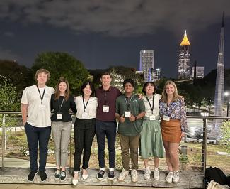 Tulane students attending the 2023 Stamps Scholars National Convention pose in Atlanta with buildings in the background.