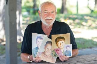 Joe Culpepper holds old family photos