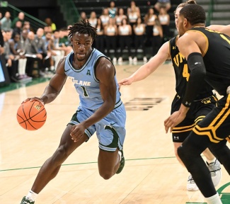 Sion James runs with a basketball in a game