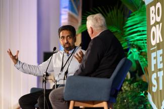 Sal Khan speaks on stage with Walter Isaacson.