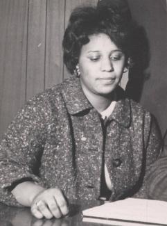 Oretha Castle Haley in 1975, looking down at papers on a table