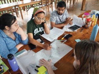 Tulane architecture students looking at papers 