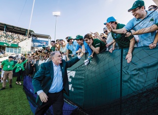 Fitts high-fives Green Wave fans at Yulman Stadium during Homecoming