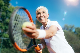 Smiling senior Woman Playing Tennis