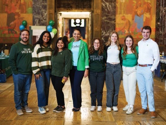 group of scholars pose in their Tulane gear in the state capitol hall