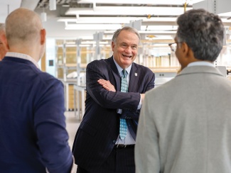 President Fitts talks with three people in a new lab 