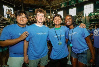 Wearing their Convocation T-shirts, students pose for a group photo.