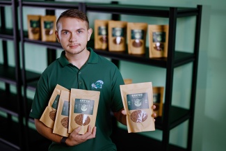 Rich Simmerman holds packages of Ceres Plant Protein Cereal