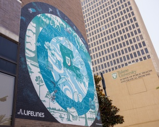 mural in blue, green and white concentric circles with Louisiana animals, plants, and instruments used in science