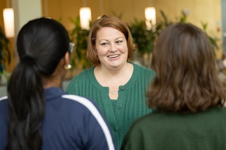 Sarah Cunningham in conversation with two students