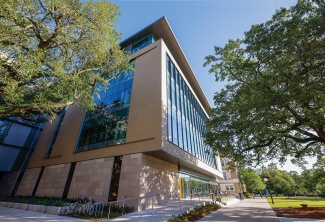 exterior of Paul Hall with trees and pathway