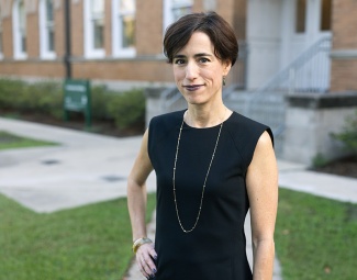 portrait of Ilianna Kwaske outside with a campus building in background