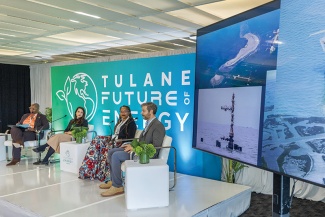 a panel of Monique Edwards, Megan Biven, Kelisha Garrett and Adam Peltz on stage