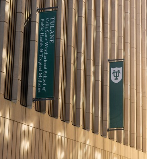 dappled sun on the Tidewater Building with green banners