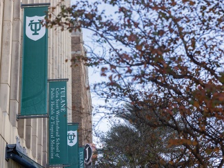 Celia Scott Weatherhead School of Public Health and Tropical Medicine building with green banners