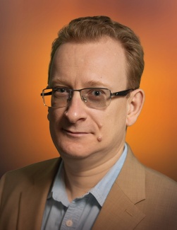 portrait of Denys Bondar against an orange background