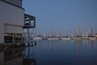 view of a marina with boats at dusk