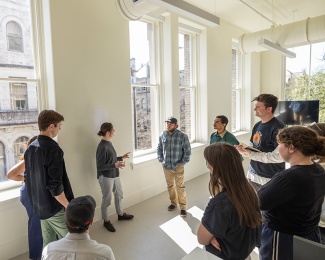 students standing in a sunlit classroom