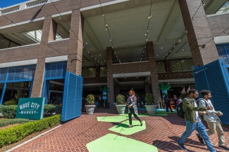 green shapes lead to the outdoor dining area of Wave City Market