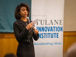 student presents an idea in front of an audience