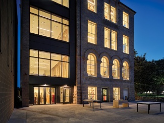 Large open patio outdoor work area at the back of Richardson Memorial Hall at dusk. 
