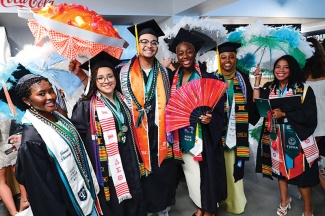 Graduates sporting garb from a variety of student organizations gather inside the Superdome before the ceremony