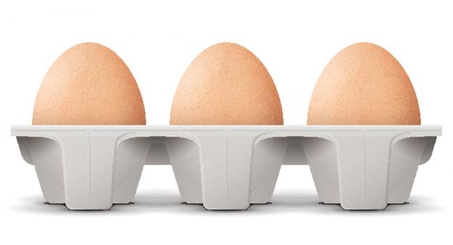 Three brown eggs sitting in egg container