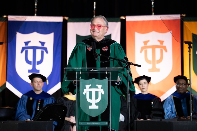 President Fitts in heart shaped sunglasses speaks to the Class of 2028