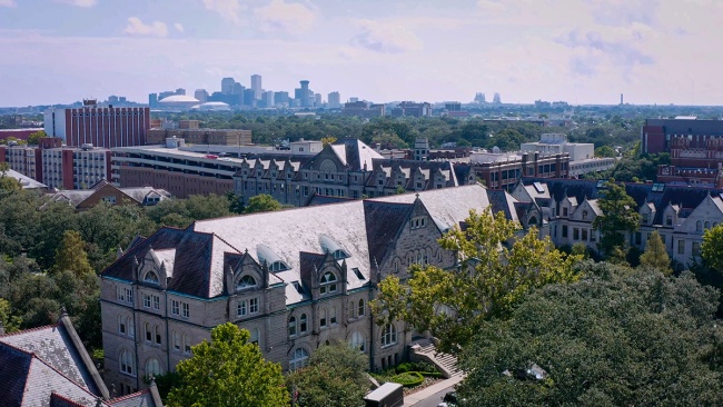 aerial view of Gibson Hall with downtown skyline in the distance