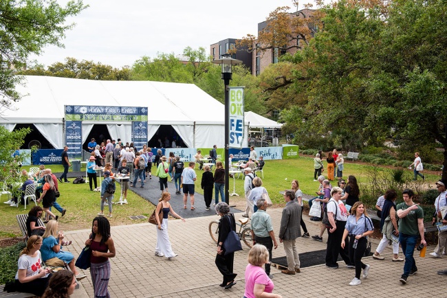 crowds of people near a festival tent on a lawn on Tulane's campus during Book Fest